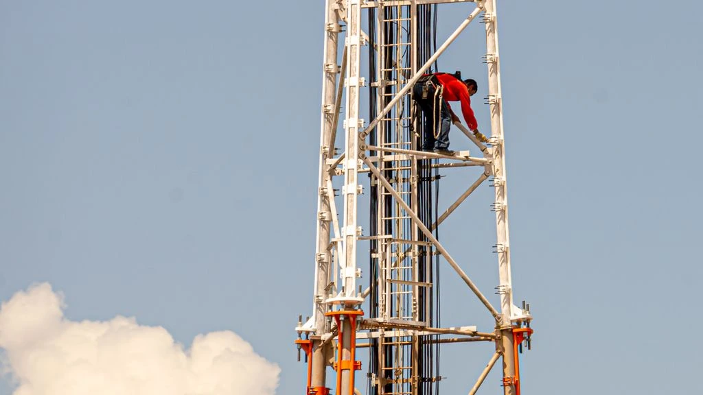 A telecom installation crew on a Bucharest rooftop